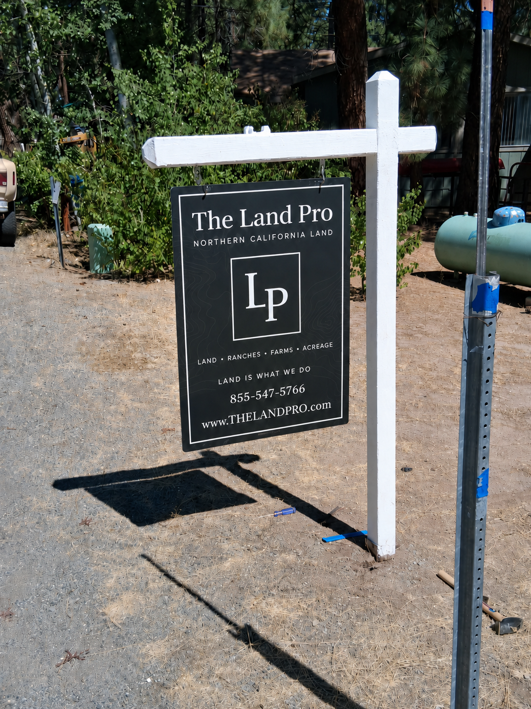 The Land Pro black reflective property sign concept reading Land Is What We Do